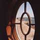 decorative oval window with view of bay in the distance